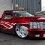 Custom lowered red truck with rims
